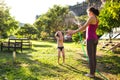 Mother sprays a child with a hose in the courtyard of the house, Boy drenched in water on a hot sunny day