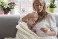 Mother staying at home with her sick child Royalty Free Stock Photo