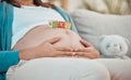 Mother, stomach and toys with a boy baby for expecting mother relaxing at home on the sofa. Child, announcement and