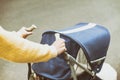 Mother strolling with newborn in carriage