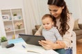 Mother student with baby and tablet pc at home Royalty Free Stock Photo