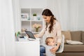 Mother student with baby and tablet pc at home Royalty Free Stock Photo