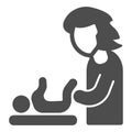 Mother swaddles baby solid icon, Mother day concept, change of diapers sign on white background, diaper change icon in