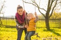 Mother swinging child outdoors