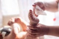 The mother takes care of the baby skin and wipes the baby`s feet with wet wipes Royalty Free Stock Photo