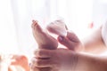 The mother takes care of the baby skin and wipes the baby`s feet with wet wipes Royalty Free Stock Photo