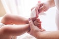 The mother takes care of the baby skin and wipes the baby`s feet with wet wipes Royalty Free Stock Photo