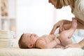 Mother taking care of little baby and changing diaper Royalty Free Stock Photo