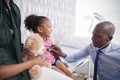 Mother Taking Daughter For Medical Exam In Doctors Office