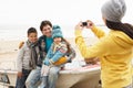 Mother Taking Family Photograph On Winter Beach Royalty Free Stock Photo