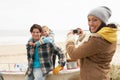 Mother Taking Family Photograph On Winter Beach Royalty Free Stock Photo