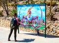 Mother taking a funny photo of a daughter in the Dino Park of Al