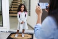 Mother Taking Photo Of Daughter With Cell Phone On First Day Back At School Royalty Free Stock Photo