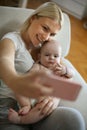 Mother taking self portrait of her and her baby boy. Royalty Free Stock Photo