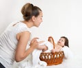 Mother talk with baby in basket on white towel, family concept Royalty Free Stock Photo