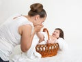 Mother talk with baby in basket on white towel, family concept Royalty Free Stock Photo