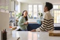 Mother Talking With Teenage Daughter At Home In Kitchen Drinking Hot Drinks Together Royalty Free Stock Photo