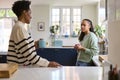 Mother Talking With Teenage Daughter At Home In Kitchen Drinking Hot Drinks Together Royalty Free Stock Photo