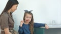 Mother talking to her little girl eating a lollipop at doctor`s office Royalty Free Stock Photo