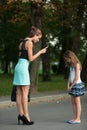 Mother talking to naughty girl on a street in park Royalty Free Stock Photo
