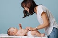 Mother talks with her infant and changes the diaper Royalty Free Stock Photo
