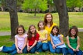 Mother teacher with daughter pupils in playground park