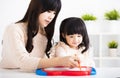 Mother or teacher helping child daughter to writing