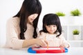 Mother or teacher helping child daughter to writing Royalty Free Stock Photo