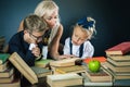 Mother or teacher helping for school kids doing homework, reading