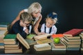 Mother or teacher helping for school kids doing homework, reading