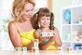 Mother teaches child letters and words playing