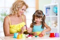 Mother teaches child to work with colorful play Royalty Free Stock Photo