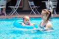 Mother teaches children swim