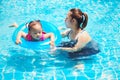 Mother teaches children swim