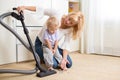 Mother teaches her child son room cleaning