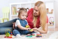 Mother teaches her child to distinguish shape and Royalty Free Stock Photo