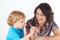 Mother teaches her child to draw with color pencils Royalty Free Stock Photo