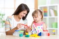 Mother teaches her child to play with colorful Royalty Free Stock Photo