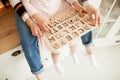 Mother teaches her daughter to read using the children`s wooden alphabet. Royalty Free Stock Photo