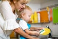 Mother teaches her little child son to wash-up Royalty Free Stock Photo