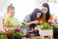 Mother teaches kids to take care of flowers and plants