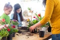 Mother teaches kids to take care of flowers and plants