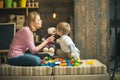 Mother teaches son to be kind and friendly. Kindness and education concept. Family play with teddy bear at home. Mom and Royalty Free Stock Photo