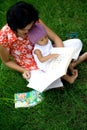 Mother teaching baby with books