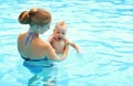 Mother teaching baby swimming pool Royalty Free Stock Photo