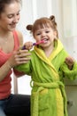 Mother teaching daughter child teeth brushing in bathroom Royalty Free Stock Photo