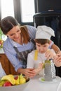 Mother Teaching Child to Cook and Help in the Kitchen Royalty Free Stock Photo