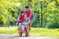 Mother teaching child to ride a bike Royalty Free Stock Photo