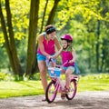 Mother teaching child to ride a bike Royalty Free Stock Photo