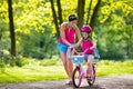 Mother teaching child to ride a bike Royalty Free Stock Photo